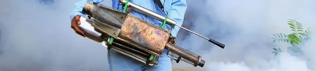 Fumigation technician using a fogger for deep pest treatment in Bloomington, IN